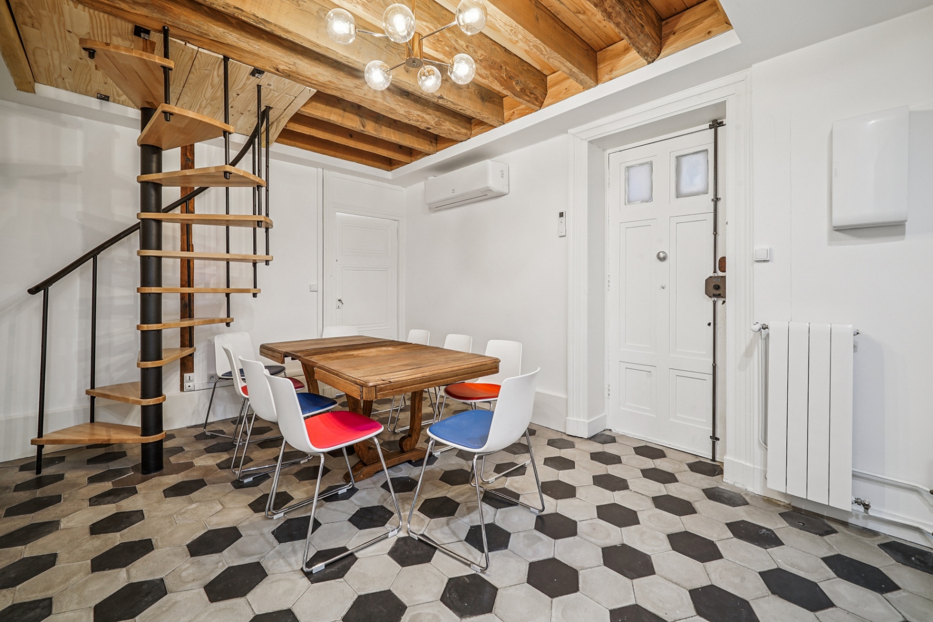 Salle à manger avec escalier en colimaçon et tomettes hexagonales
